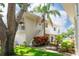 Two-story home with white exterior and a small balcony above garage, set amongst a green lawn at 2943 Bough Ave # C, Clearwater, FL 33760