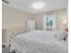Bright main bedroom showcasing white furniture, a large bed, and carpeted floors at 2943 Bough Ave # C, Clearwater, FL 33760