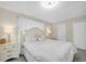 Main bedroom featuring a large bed with white bedding, side tables and carpeted floors at 2943 Bough Ave # C, Clearwater, FL 33760