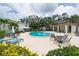 Inviting community pool surrounded by lounge chairs and lush landscaping, perfect for relaxation at 2943 Bough Ave # C, Clearwater, FL 33760