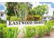 Eastwood Shores sign surrounded by colorful shrubbery, establishing the community's name and location at 2943 Bough Ave # C, Clearwater, FL 33760