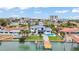 Aerial view showcasing a stunning waterfront home with a private pool and dock, surrounded by lush landscaping at 319 Midway Is, Clearwater Beach, FL 33767