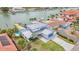Aerial view of beautiful waterfront home with metal roof, private dock, pool, and lush landscaping at 319 Midway Is, Clearwater Beach, FL 33767