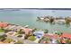 A gorgeous aerial view shows this waterfront home is nestled among lush tropical landscaping at 319 Midway Is, Clearwater Beach, FL 33767