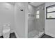 Modern bathroom featuring stylish glass enclosed shower with decorative tile accents and contemporary fixtures at 319 Midway Is, Clearwater Beach, FL 33767