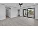 Spacious bedroom with a ceiling fan, en-suite bathroom, and access to a private balcony at 319 Midway Is, Clearwater Beach, FL 33767