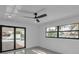 Bright bedroom with a door to the patio and a large window at 319 Midway Is, Clearwater Beach, FL 33767