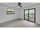 Bright bedroom with a view and a sliding glass door to a balcony at 319 Midway Is, Clearwater Beach, FL 33767