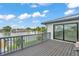 Enjoy this relaxing deck view with grey outdoor railings, decking, and access to the Primary bedroom via sliding glass doors at 319 Midway Is, Clearwater Beach, FL 33767