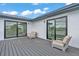 Relax in comfort on this outdoor deck featuring outdoor seating and entrances to the home via sliding glass doors at 319 Midway Is, Clearwater Beach, FL 33767