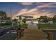 Beautiful waterfront home with lush landscaping, a private dock, and a gray paver driveway at 319 Midway Is, Clearwater Beach, FL 33767