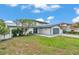 Well-maintained home with a lush green lawn, mature landscaping, and a two-car garage at 319 Midway Is, Clearwater Beach, FL 33767