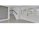 Bright foyer featuring decorative glass double doors, modern staircase, and sleek tile flooring at 319 Midway Is, Clearwater Beach, FL 33767
