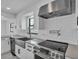 Well-equipped kitchen featuring stainless steel appliances, modern cabinets, and elegant countertops at 319 Midway Is, Clearwater Beach, FL 33767