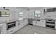 Kitchen featuring white cabinets, stainless steel appliances, and tile backsplash offering a clean and modern aesthetic at 319 Midway Is, Clearwater Beach, FL 33767