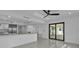 Open-concept living space featuring modern kitchen, bright recessed lighting and sliding glass doors at 319 Midway Is, Clearwater Beach, FL 33767