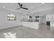 Modern living space featuring an open kitchen, sleek flooring, and ample natural light throughout at 319 Midway Is, Clearwater Beach, FL 33767