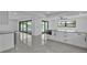 Open-concept living space with sleek modern finishes, tile flooring, and water views at 319 Midway Is, Clearwater Beach, FL 33767