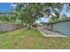Spacious back yard with a mature tree, patio area and a play structure for outdoor enjoyment at 3619 15Th Se Ave, Largo, FL 33771