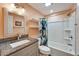 This bathroom features a granite vanity, a shower with a decorative curtain, and floating shelves at 3619 15Th Se Ave, Largo, FL 33771