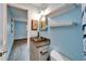 Hallway Bathroom featuring a granite countertop, wicker mirror, under vanity storage and neutral paint at 3619 15Th Se Ave, Largo, FL 33771