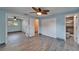 Bedroom featuring wood-look tile flooring, a ceiling fan, a window, and access to the bathroom at 3619 15Th Se Ave, Largo, FL 33771