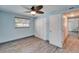Bedroom featuring wood-look tile flooring, neutral paint, a ceiling fan, and a closet with sliding doors at 3619 15Th Se Ave, Largo, FL 33771