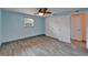 Bedroom featuring wood-look tile flooring, a ceiling fan, a window, and closet with double doors at 3619 15Th Se Ave, Largo, FL 33771
