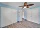 This bedroom features a ceiling fan, wood flooring, and white closets at 3619 15Th Se Ave, Largo, FL 33771