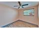 This cozy bedroom features a ceiling fan, wood flooring, and a window at 3619 15Th Se Ave, Largo, FL 33771