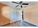 This bedroom has wood flooring, a ceiling fan, a closet, and an open door at 3619 15Th Se Ave, Largo, FL 33771