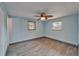 Bedroom featuring wood-look tile flooring, two windows, neutral paint, a ceiling fan, and baseboard trim at 3619 15Th Se Ave, Largo, FL 33771