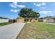 Charming front exterior with a lush lawn, long driveway and a one car garage at 3619 15Th Se Ave, Largo, FL 33771