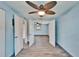 Hallway featuring wood-look tile flooring, neutral paint, and doorways to bedrooms and bathrooms at 3619 15Th Se Ave, Largo, FL 33771