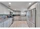Bright kitchen with stainless steel appliances, granite countertops, and wood-look tile flooring at 3619 15Th Se Ave, Largo, FL 33771