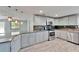 Open concept kitchen featuring stainless steel appliances and stone countertops at 3619 15Th Se Ave, Largo, FL 33771