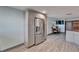 Kitchenette featuring stainless steel refrigerator with grey cabinets and wood-look flooring at 3619 15Th Se Ave, Largo, FL 33771