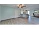 Open living area with wood-look flooring, ceiling fan, and access to kitchen at 3619 15Th Se Ave, Largo, FL 33771