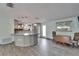 Open concept living and kitchen space with lots of light and wood-look floors at 3619 15Th Se Ave, Largo, FL 33771