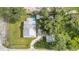Overhead view of a well-maintained property with a house, pool, shed, and driveway at 36725 Arcadia Ave, Myakka City, FL 34251