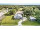 Aerial view of home with well-manicured lawn, fenced yard, storage shed, and gravel driveway at 36725 Arcadia Ave, Myakka City, FL 34251