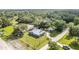 Aerial view of a fenced property with a well-maintained lawn and multiple outbuildings at 36725 Arcadia Ave, Myakka City, FL 34251