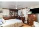 Spacious bedroom features wood furniture, a ceiling fan, and ample natural light at 36725 Arcadia Ave, Myakka City, FL 34251