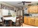 Charming dining area featuring a wooden table set, cottage curtains, and built in cabinets at 36725 Arcadia Ave, Myakka City, FL 34251