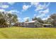 Aerial view showcasing a well-maintained home with metal roof and large yard at 36725 Arcadia Ave, Myakka City, FL 34251