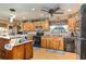 Well-equipped kitchen with rustic wood cabinets, modern appliances, and ample counter space at 36725 Arcadia Ave, Myakka City, FL 34251
