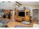 Inviting living room featuring wood-look floors and an entertainment center, adjacent to the kitchen at 36725 Arcadia Ave, Myakka City, FL 34251