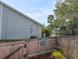Well-maintained fenced backyard with a charming gate and lush greenery at 39650 Us Hwy 19 N, Tarpon Springs, FL 34689