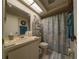 Well-maintained bathroom with a vanity, toilet, and shower/tub combo with themed curtain at 39650 Us Hwy 19 N, Tarpon Springs, FL 34689