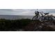 Two bicycles rest on sandy terrain with beach vegetation, showcasing the proximity to nature and outdoor activities at 39650 Us Hwy 19 N, Tarpon Springs, FL 34689